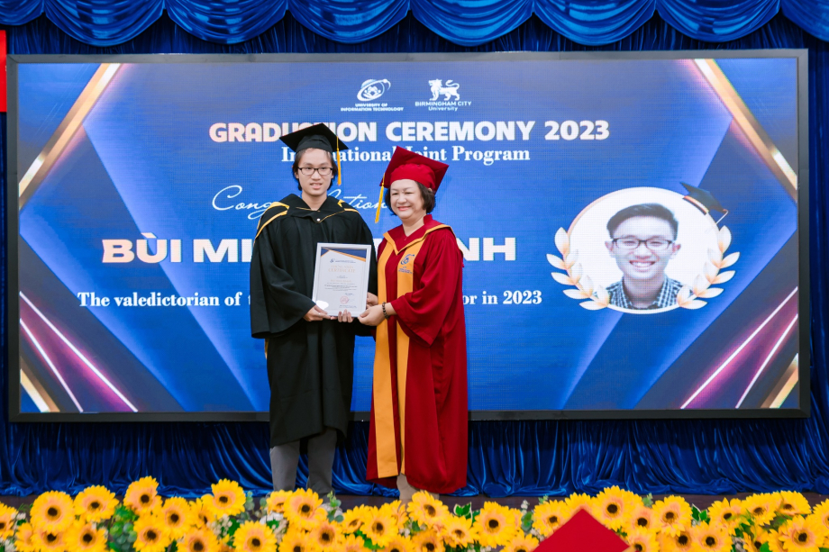 A person and person in graduation gowns
Description automatically generated